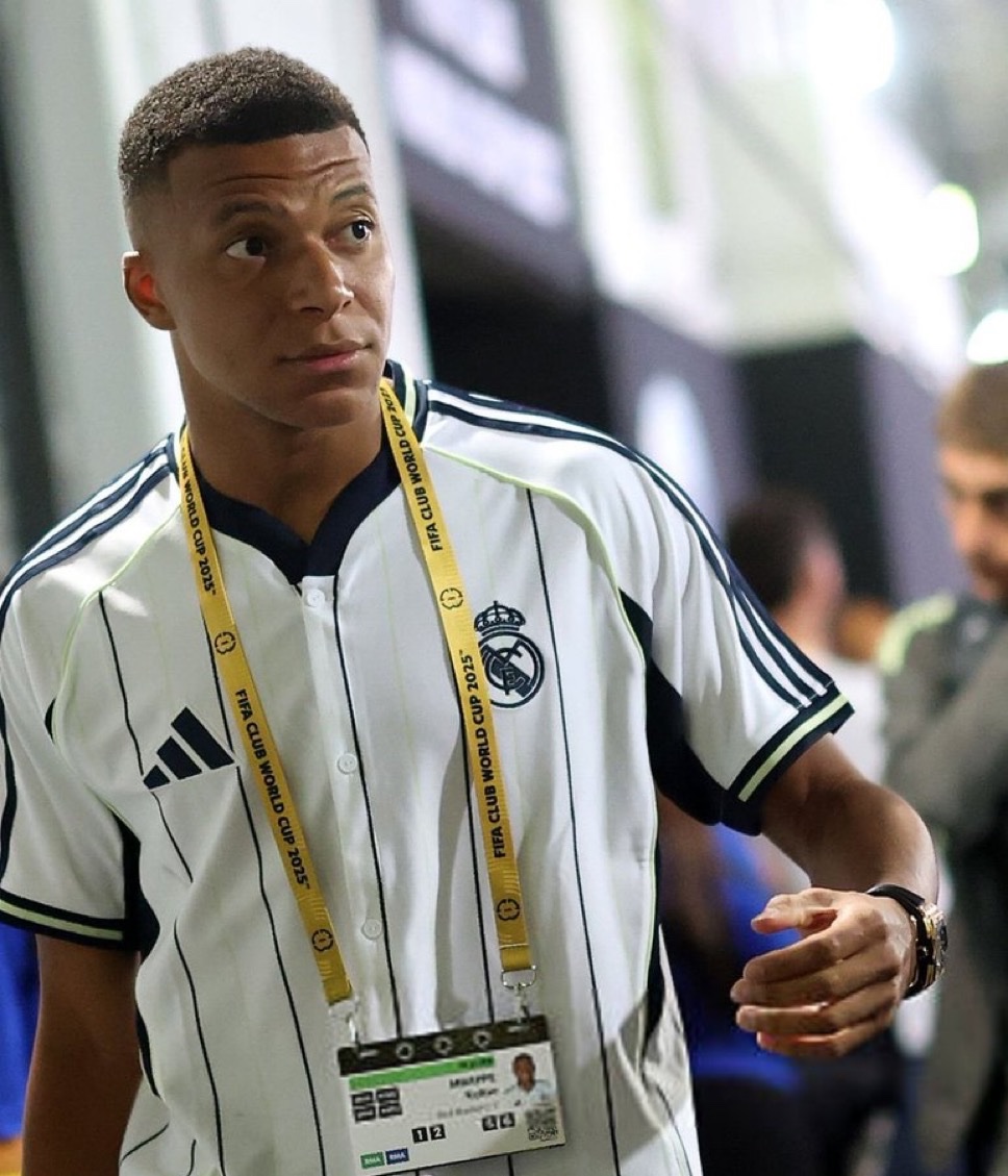 This isn’t just a game; it’s a fiery clash of pride, betrayal, and redemption that has fans buzzing with anticipation. FIFA, eager to elevate the tournament’s reputation after criticism for its “disorganized planning and lackluster execution,” sees this “grudge match” as the perfect blockbuster to captivate global audiences. The drama centers on Mbappé’s messy exit from PSG, where he spent **seven unforgettable seasons**, lighting up the pitch with dazzling goals and hoisting countless trophies. His departure on a **free transfer** left a bitter taste—no farewell ceremony, no transfer fee, just boos from PSG fans and a lingering sense of betrayal. The fallout turned ugly, spiraling into a **legal battle** over unpaid wages, with public barbs exposing raw wounds. Though Mbappé recently hinted at mending ties, dropping harassment claims against PSG, the scars of this “nasty divorce” fuel the intensity of this matchup. Fans still whisper about the hurt, and social media is ablaze with speculation about how this reunion will unfold. For PSG, life without Mbappé has been nothing short of triumphant. Under the steady hand of manager **Luis Enrique**, the team has been a juggernaut, sweeping **Ligue 1, the Coupe de France, the Trophée des Champions, and the UEFA Champions League** in what’s been hailed as the **greatest season in the club’s history**. Enrique’s bold claim that PSG is “stronger in attack and defense” without Mbappé isn’t just talk—their trophy cabinet backs it up. Players like **Ousmane Dembélé** and **Bradley Barcola** have stepped into the spotlight, their chemistry on the pitch electric, proving the team’s depth and resilience. PSG fans, once heartbroken, now rally behind their new heroes, dreaming of capping this golden era with a Club World Cup title. Meanwhile, Mbappé’s journey at Real Madrid has been a rollercoaster. His start in Spain has been rocky—an early **Champions League exit**, a **La Liga title loss to Barcelona**, and whispers from critics labeling him a “curse.” The pressure is immense for the young star, who carries the weight of proving his move was a step up, not a misstep. But Mbappé is showing signs of rediscovering his magic. After battling a stomach bug that sidelined him, he roared back with a jaw-dropping **acrobatic volley against Dortmund** and a lively cameo off the bench against Juventus. “I’m back, and I’m ready,” he seemed to declare, his confidence palpable. Off the pitch, he stirred the pot with a cryptic Instagram story showcasing a PSG jersey alongside the word “goat”—a nod to his “Greatest Of All Time” status and a cheeky jab tied to a PSG sponsor. Fans on X lit up, debating whether it was a taunt or a tribute. This match is a collision of narratives: **pride, power, and payback**. For Mbappé, it’s a chance to silence doubters and show PSG he’s thriving without them. For PSG, it’s an opportunity to prove they’ve moved on, stronger than ever. The world will be glued to their screens, not just for the football but for the raw emotion—every tackle, every goal, every glance between Mbappé and his former teammates will carry the weight of their shared history. As one X post put it, “This isn’t just a semi-final; it’s personal, and it’s going to be absolute fireworks.”